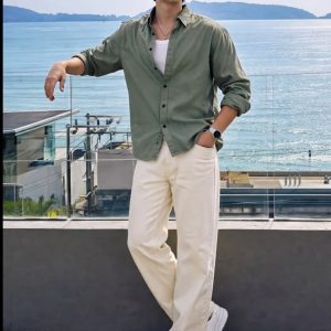 Men's olive green casual shirt with white trousers by the beach